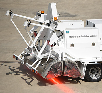 Truck with contraption on back that is projecting a bright beam of light on the ground. Truck with contraption on back that is projecting a bright beam of light on the ground.
