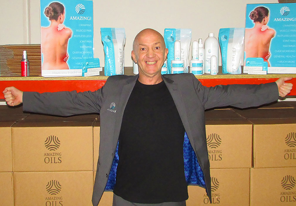 Person posing in front of bottles of the amazing oil product Person posing in front of bottles of the amazing oil product