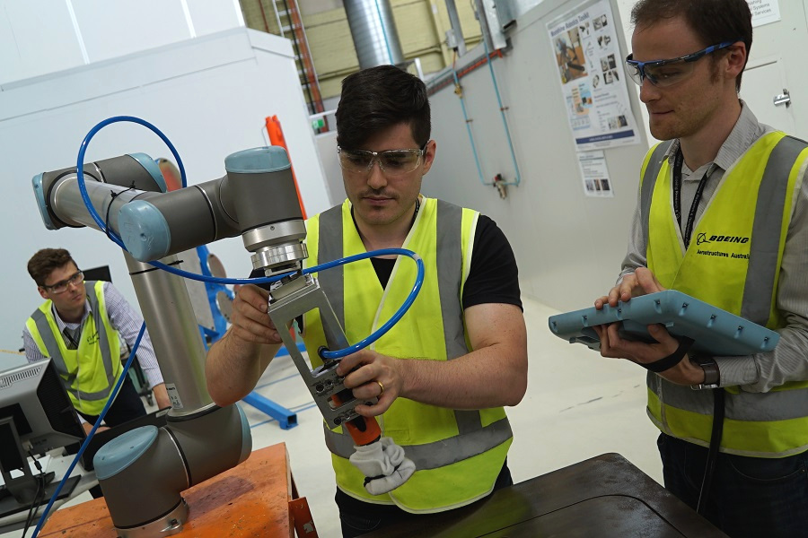Workers at Boeing Aerostructures Australia work with new technologies. Workers at Boeing Aerostructures Australia work with new technologies.