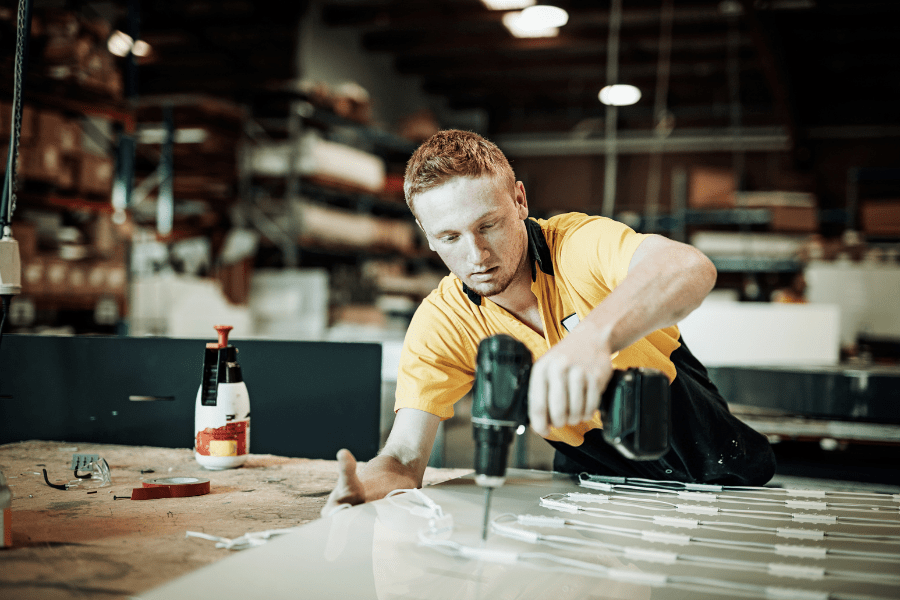 A man in the construction industry using a drill